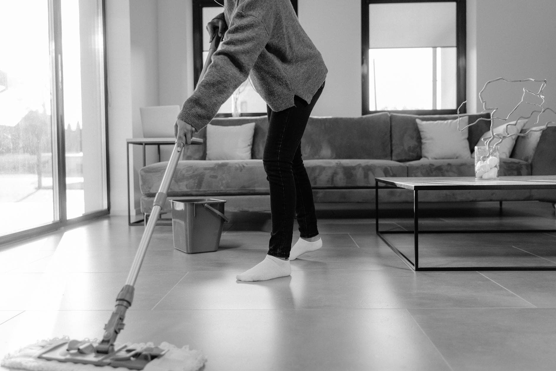 Professional NYC cleaner mopping the floor in a modern apartment living room — Regular Apartment Cleaning in Old Town, Staten Island