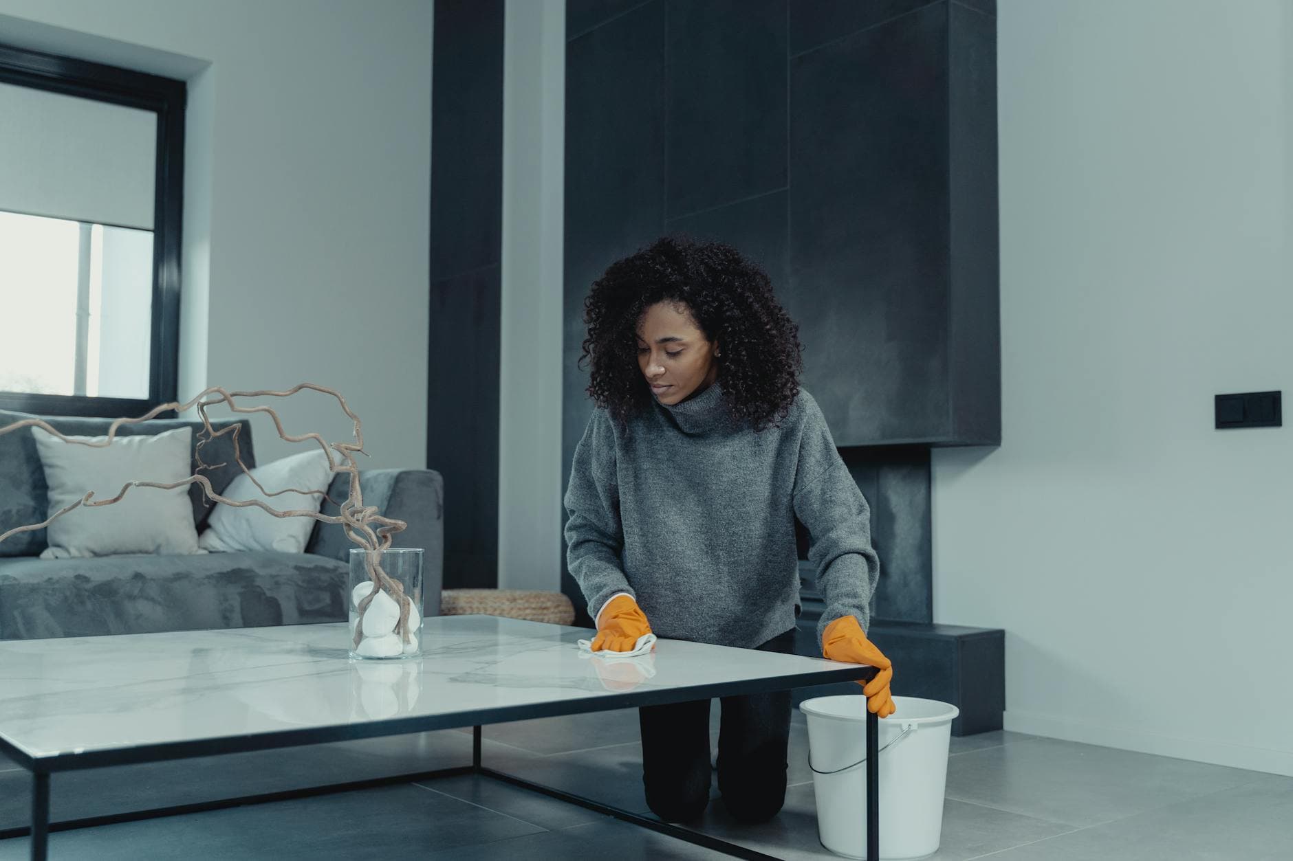 Professional house cleaner wiping a table in a contemporary New York apartment — Bi-Weekly Cleaning in Hillcrest, Queens